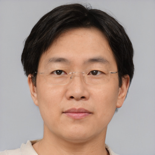 Joyful asian adult male with short  brown hair and brown eyes