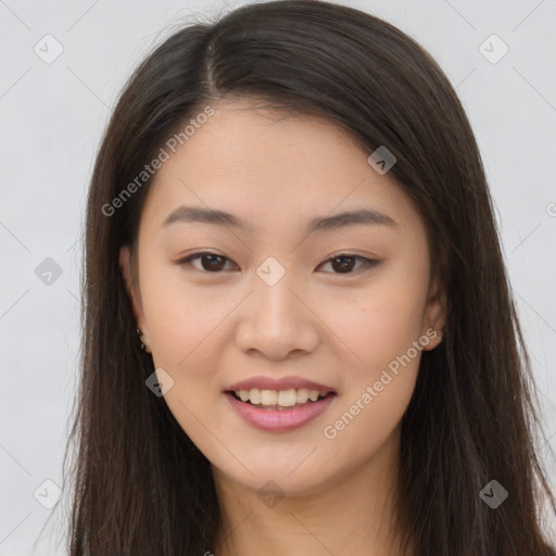 Joyful asian young-adult female with long  brown hair and brown eyes