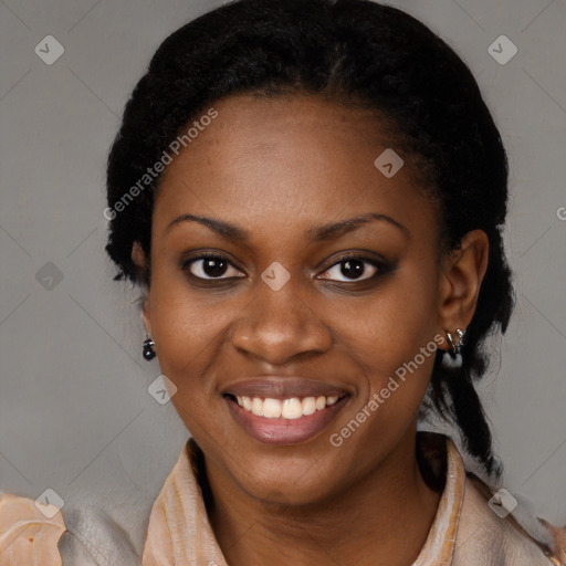 Joyful black young-adult female with long  black hair and brown eyes