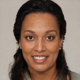 Joyful black adult female with medium  brown hair and brown eyes