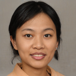 Joyful asian young-adult female with medium  brown hair and brown eyes