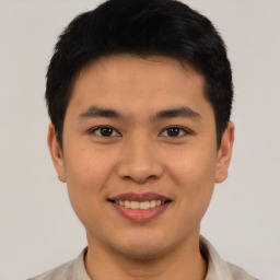 Joyful asian young-adult male with short  black hair and brown eyes