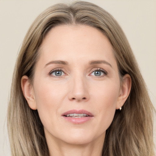 Joyful white adult female with long  brown hair and grey eyes