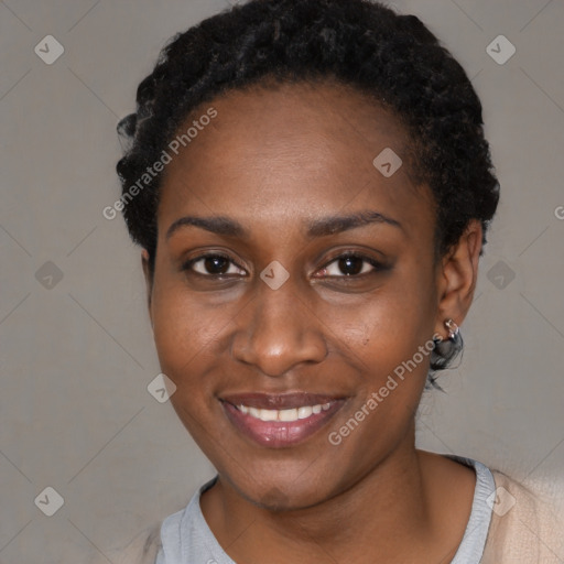 Joyful black young-adult female with short  black hair and brown eyes