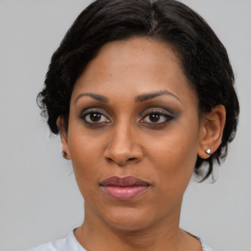 Joyful black young-adult female with short  brown hair and brown eyes
