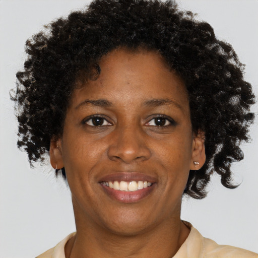 Joyful black young-adult female with short  brown hair and brown eyes