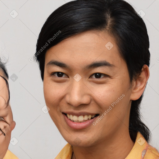 Joyful asian young-adult male with medium  brown hair and brown eyes