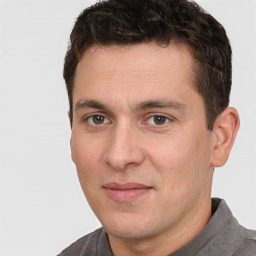 Joyful white adult male with short  brown hair and brown eyes