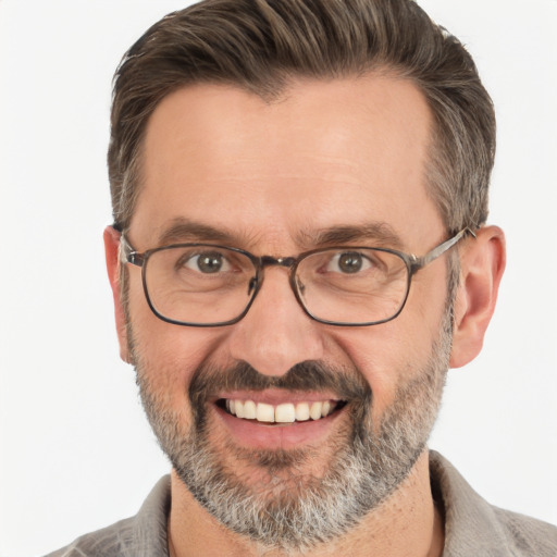 Joyful white adult male with short  brown hair and brown eyes