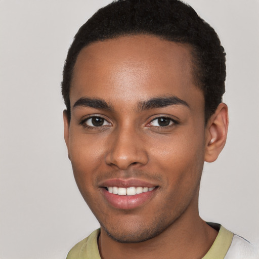 Joyful black young-adult male with short  brown hair and brown eyes