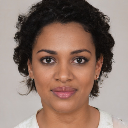 Joyful black young-adult female with medium  brown hair and brown eyes