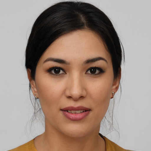Joyful latino young-adult female with medium  brown hair and brown eyes