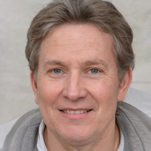 Joyful white adult male with short  brown hair and grey eyes