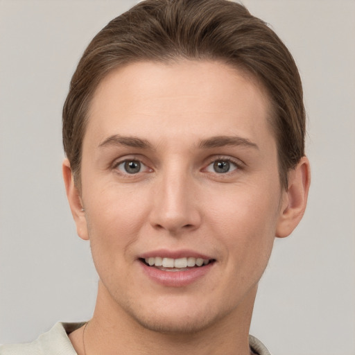 Joyful white young-adult female with short  brown hair and grey eyes