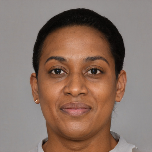 Joyful black adult female with short  black hair and brown eyes