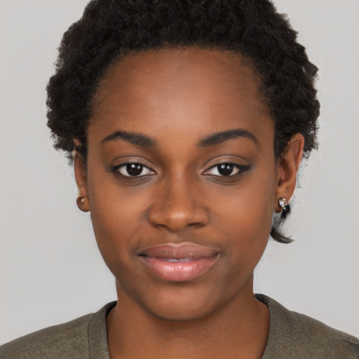 Joyful black young-adult female with short  black hair and brown eyes