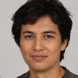 Joyful latino adult male with short  brown hair and brown eyes