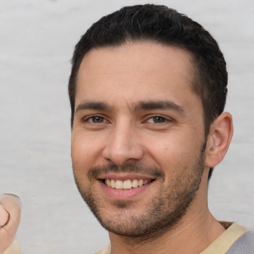 Joyful white young-adult male with short  brown hair and brown eyes