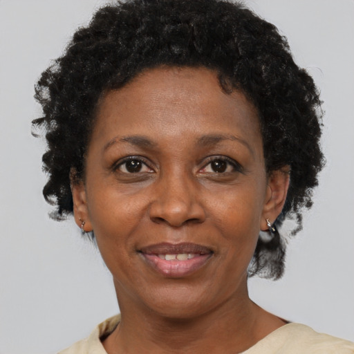 Joyful black adult female with short  brown hair and brown eyes