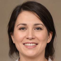 Joyful white adult female with medium  brown hair and brown eyes