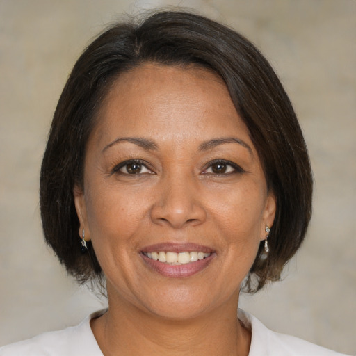 Joyful white adult female with medium  brown hair and brown eyes