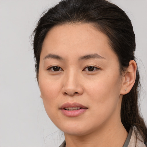 Joyful asian young-adult female with medium  brown hair and brown eyes