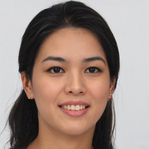 Joyful asian young-adult female with long  black hair and brown eyes