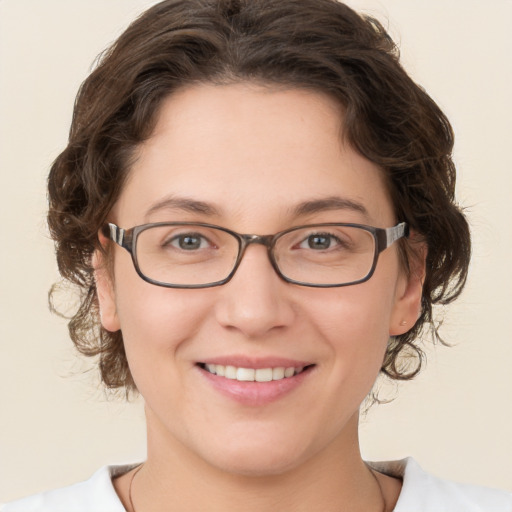 Joyful white young-adult female with medium  brown hair and brown eyes