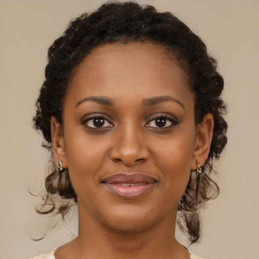 Joyful black young-adult female with medium  brown hair and brown eyes