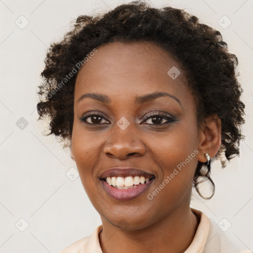 Joyful black young-adult female with short  brown hair and brown eyes