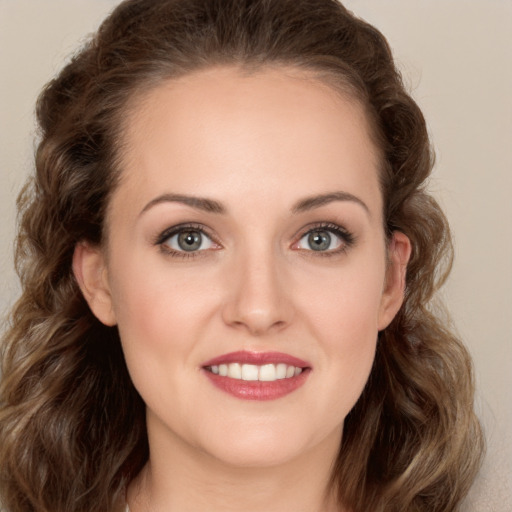 Joyful white young-adult female with long  brown hair and green eyes