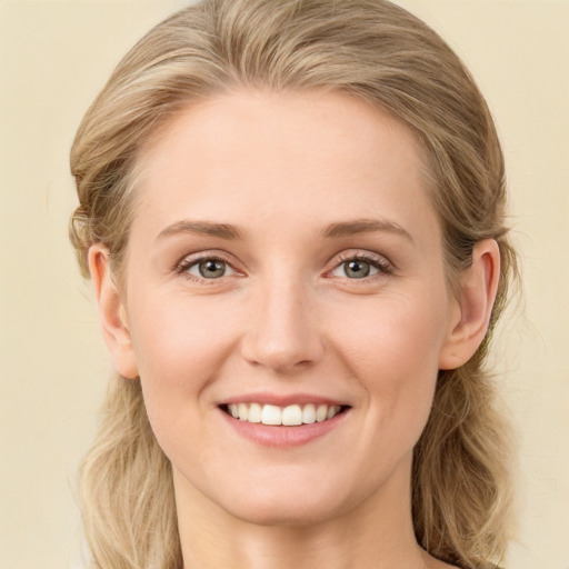 Joyful white young-adult female with long  brown hair and blue eyes