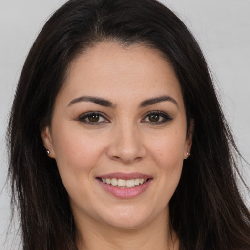Joyful white young-adult female with long  brown hair and brown eyes