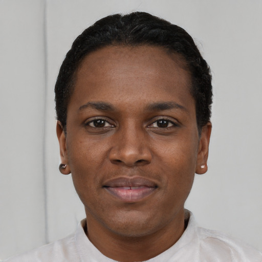 Joyful black young-adult female with short  black hair and brown eyes