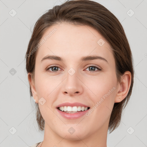 Joyful white young-adult female with medium  brown hair and grey eyes