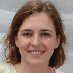 Joyful white young-adult female with medium  brown hair and blue eyes