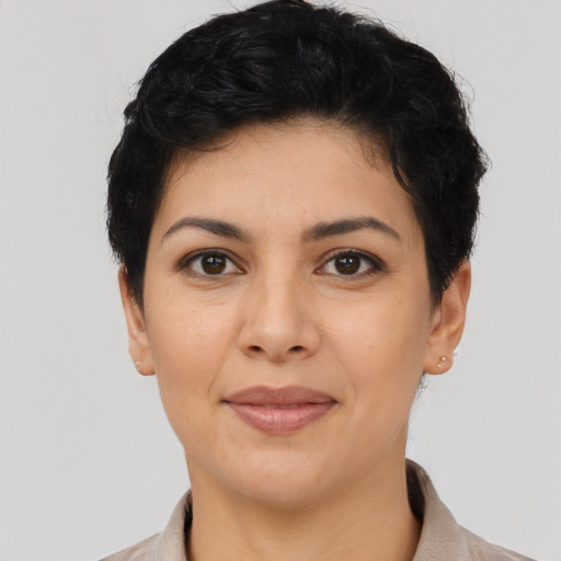Joyful latino young-adult female with short  black hair and brown eyes