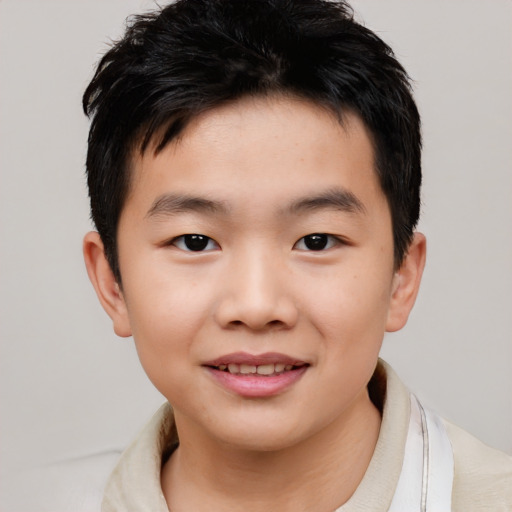 Joyful asian child male with short  brown hair and brown eyes
