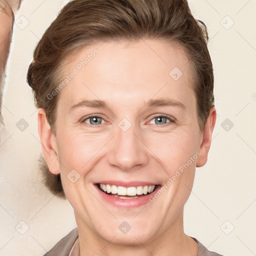 Joyful white young-adult female with short  brown hair and grey eyes