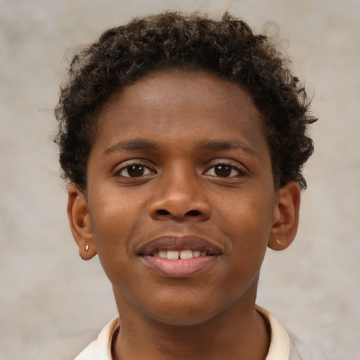 Joyful black child male with short  brown hair and brown eyes
