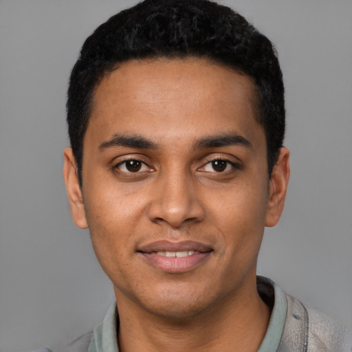 Joyful latino young-adult male with short  black hair and brown eyes