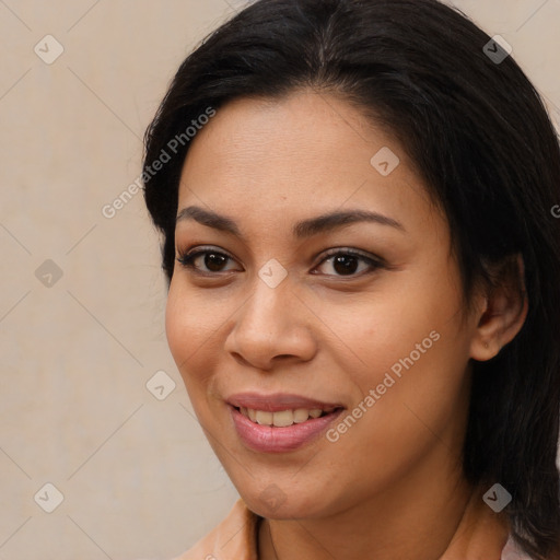 Joyful latino young-adult female with long  brown hair and brown eyes