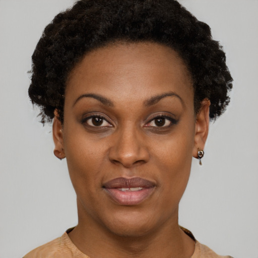 Joyful black young-adult female with short  brown hair and brown eyes