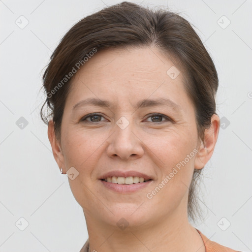 Joyful white adult female with short  brown hair and brown eyes