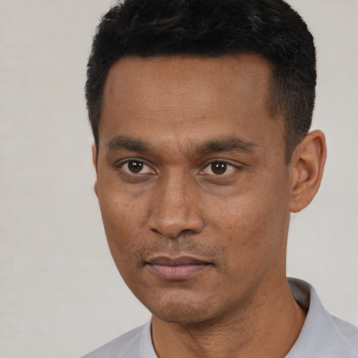 Neutral latino young-adult male with short  black hair and brown eyes