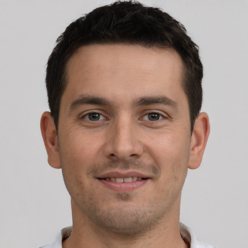 Joyful white young-adult male with short  brown hair and brown eyes