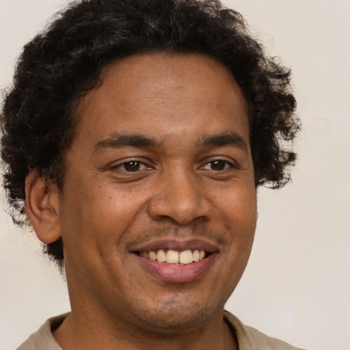 Joyful latino young-adult male with short  brown hair and brown eyes