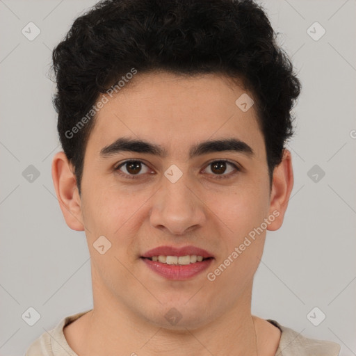 Joyful latino young-adult male with short  brown hair and brown eyes