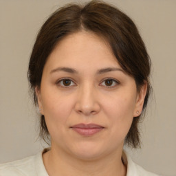 Joyful white adult female with medium  brown hair and brown eyes