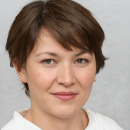 Joyful white adult female with medium  brown hair and brown eyes